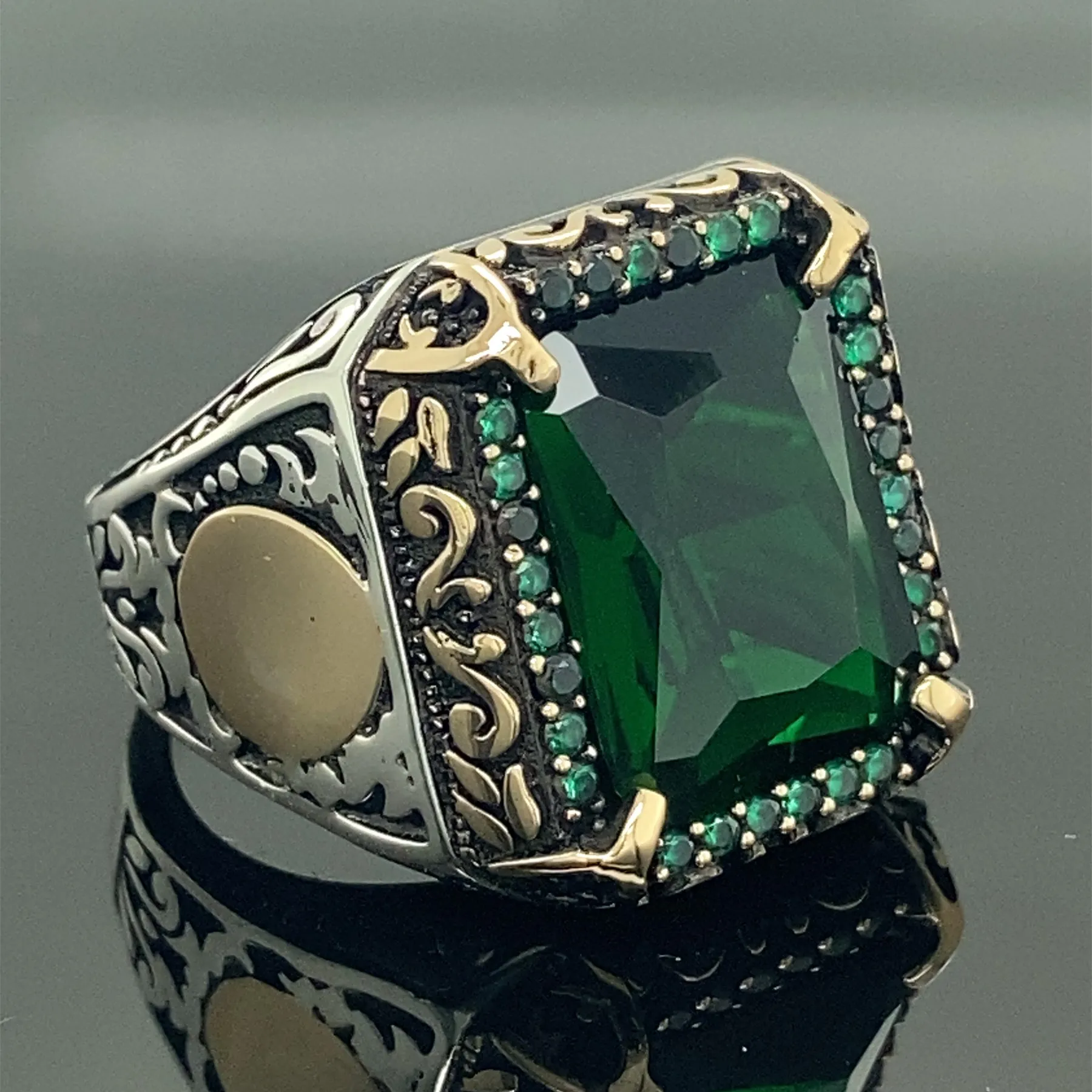 Silver ring with a green gem on Craiyon