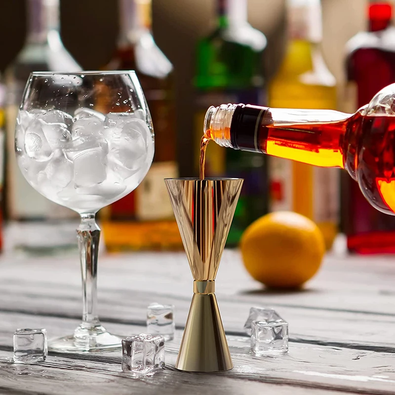 Assorted stainless steel cocktail jiggers for precise drink measurement in different sizes and finishes