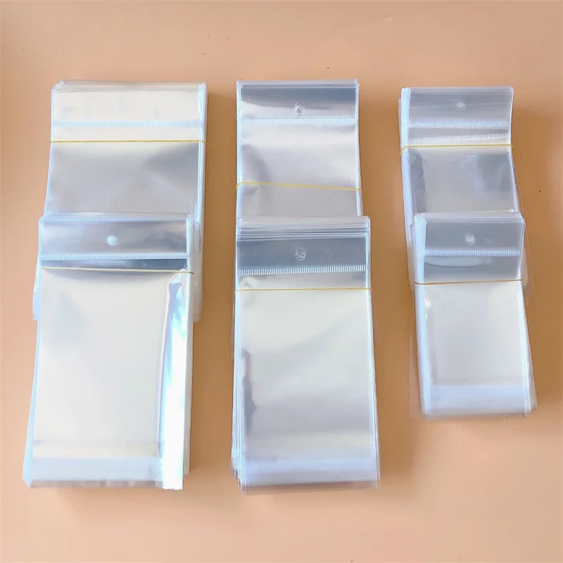 100pcs Clear Self-adhesive Opp Bag Self Sealing Small Plastic Bags for Candy Jewelry Packing Resealable Bag With Hole 100pcs various size 5x7 6x9 7x11cm resealable poly bag transparent opp plastic bags self adhesive seal jewellery making bag