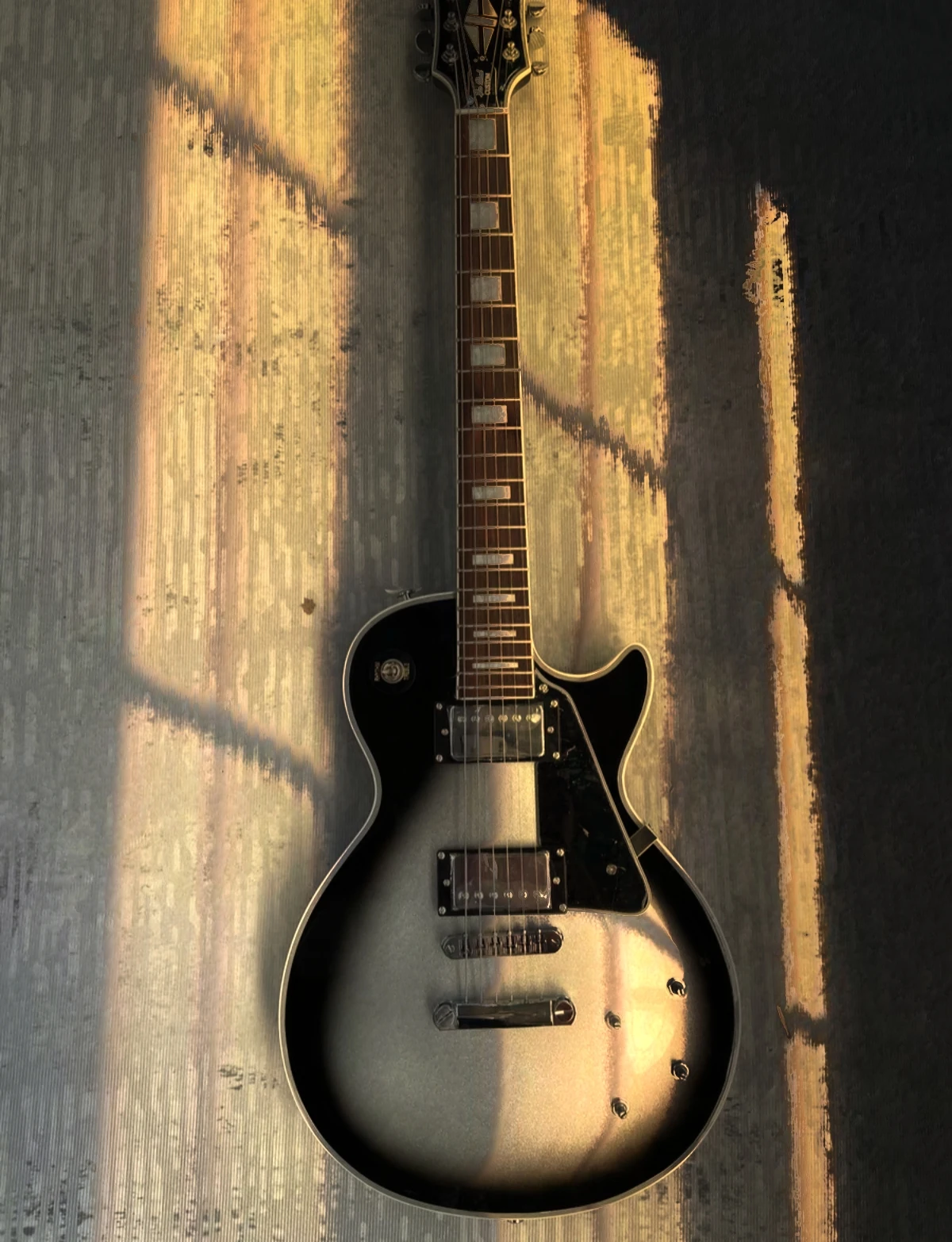 

Silver black six-string electric guitar silver pickup black guard