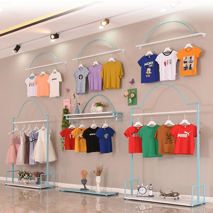 

Racks in boys' and girls' clothing stores Blue wall children's store display shelves Hanging clothes shelves in shopping malls