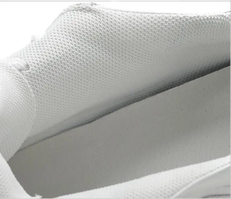 Detail of airy white mesh lining and cushioned insole for breathability.