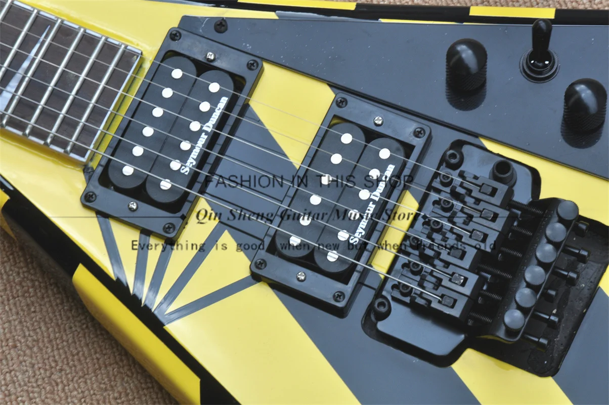 Black-yellow electric guitar, V-shaped guitar, tremolo bridge