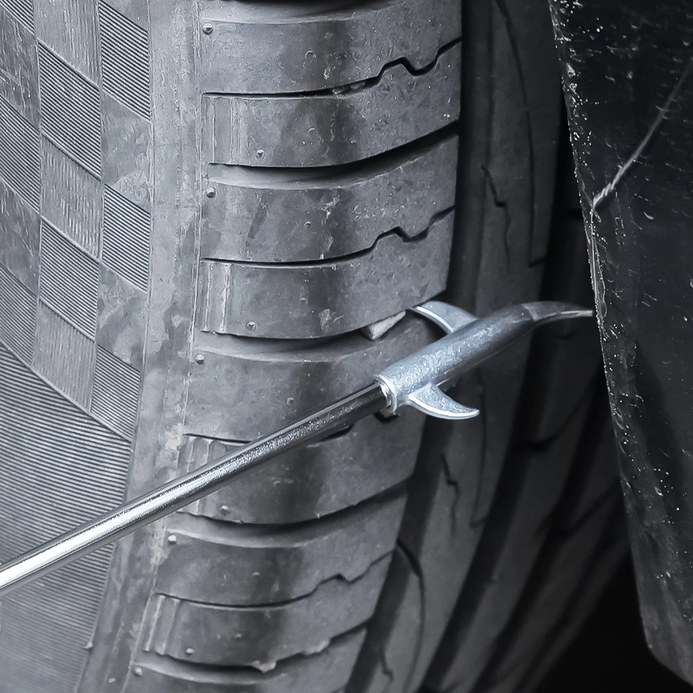 Side view of the stainless steel tire stone remover tool showing the 2026 hook design. Side view of the stainless steel tire stone remover tool showing the 2026 hook design.