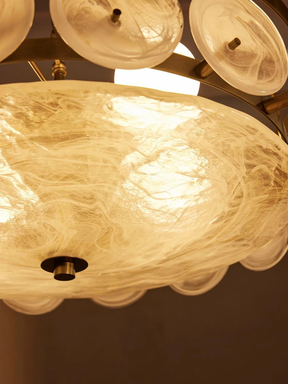 Close-up view of the Italian Retro Pendant Light featuring circular, translucent panels and a textured, illuminated surface, reminiscent of a Mid-Century Modern chandelier.