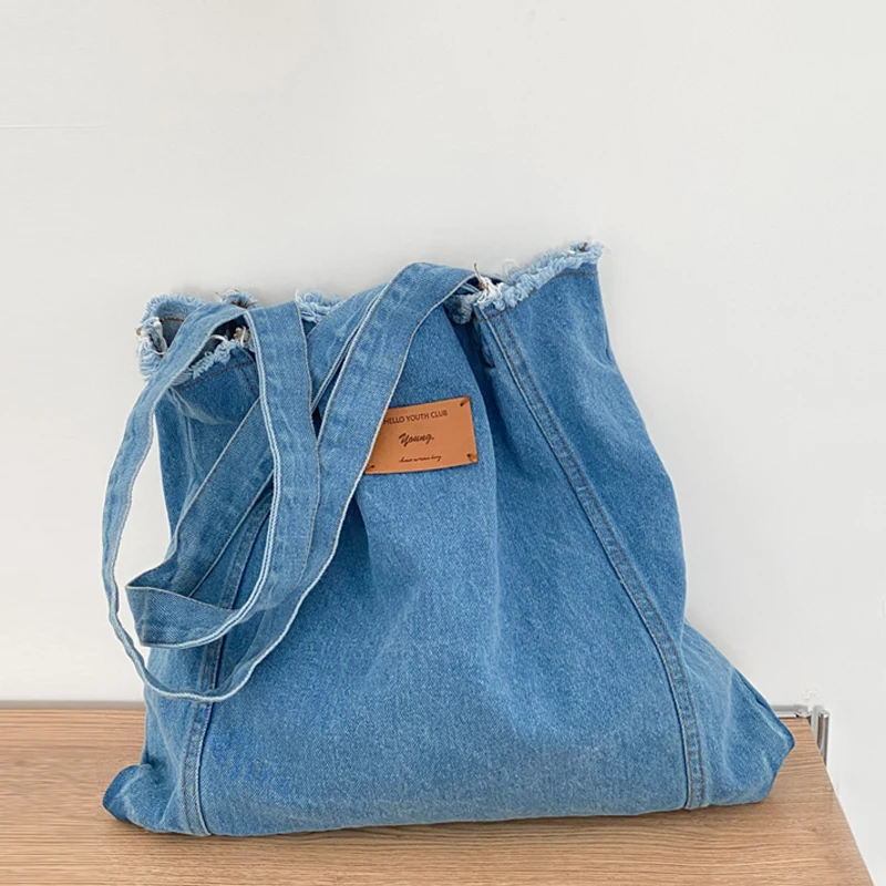 thumbnail image 1 of Bolso de mano grande y monedero de estilo preppy Bolso de diseñador de lujo para mujer 2023 Nuevo en bolso de hombro de tela con borlas y letras de mezclilla, 1 of 5