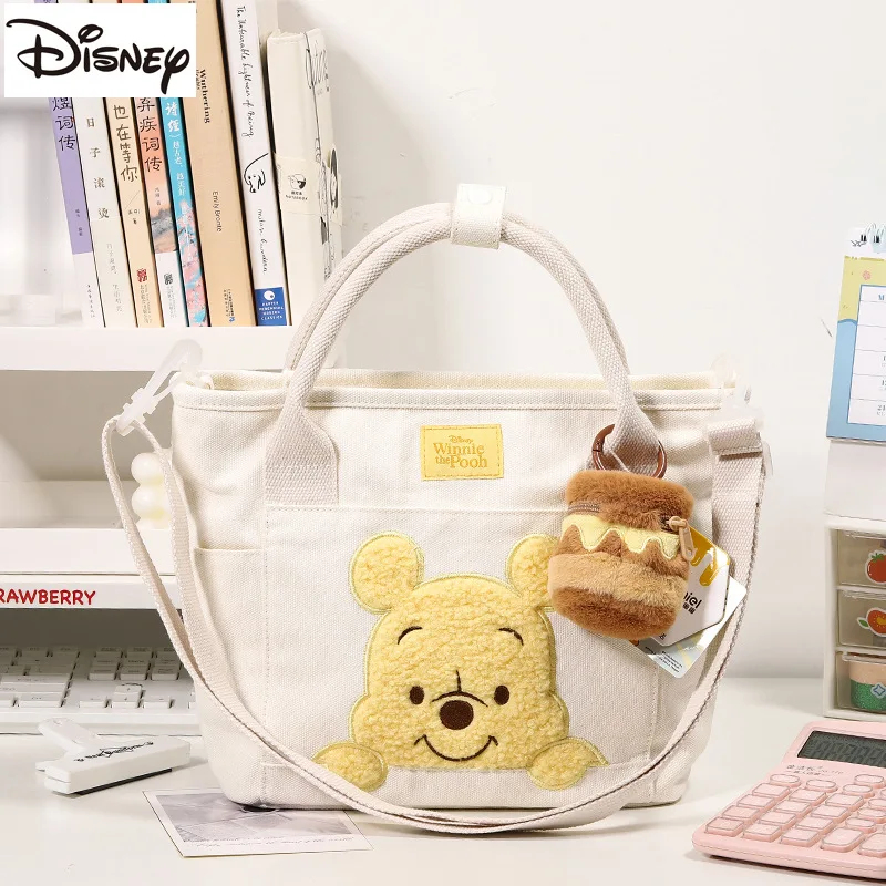 thumbnail image 1 of Bolso de hombro de gran capacidad con colgante de Winnie The Pooh original de Disney, diseño de oso de abeja kawaii, bolso de mano portátil de dibujos animados de Anime para niñas, 1 of 4