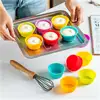 Bright silicone cupcake liners in yellow, red, blue, pink, and orange for baking muffins, cupcakes, or desserts, ideal for kitchen use and food presentation.