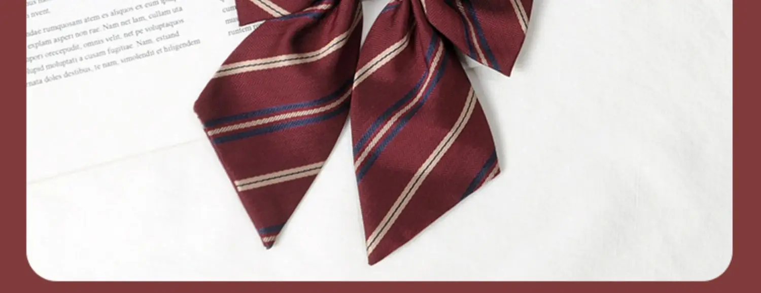 Multiple striped bow ties displayed on white and book background