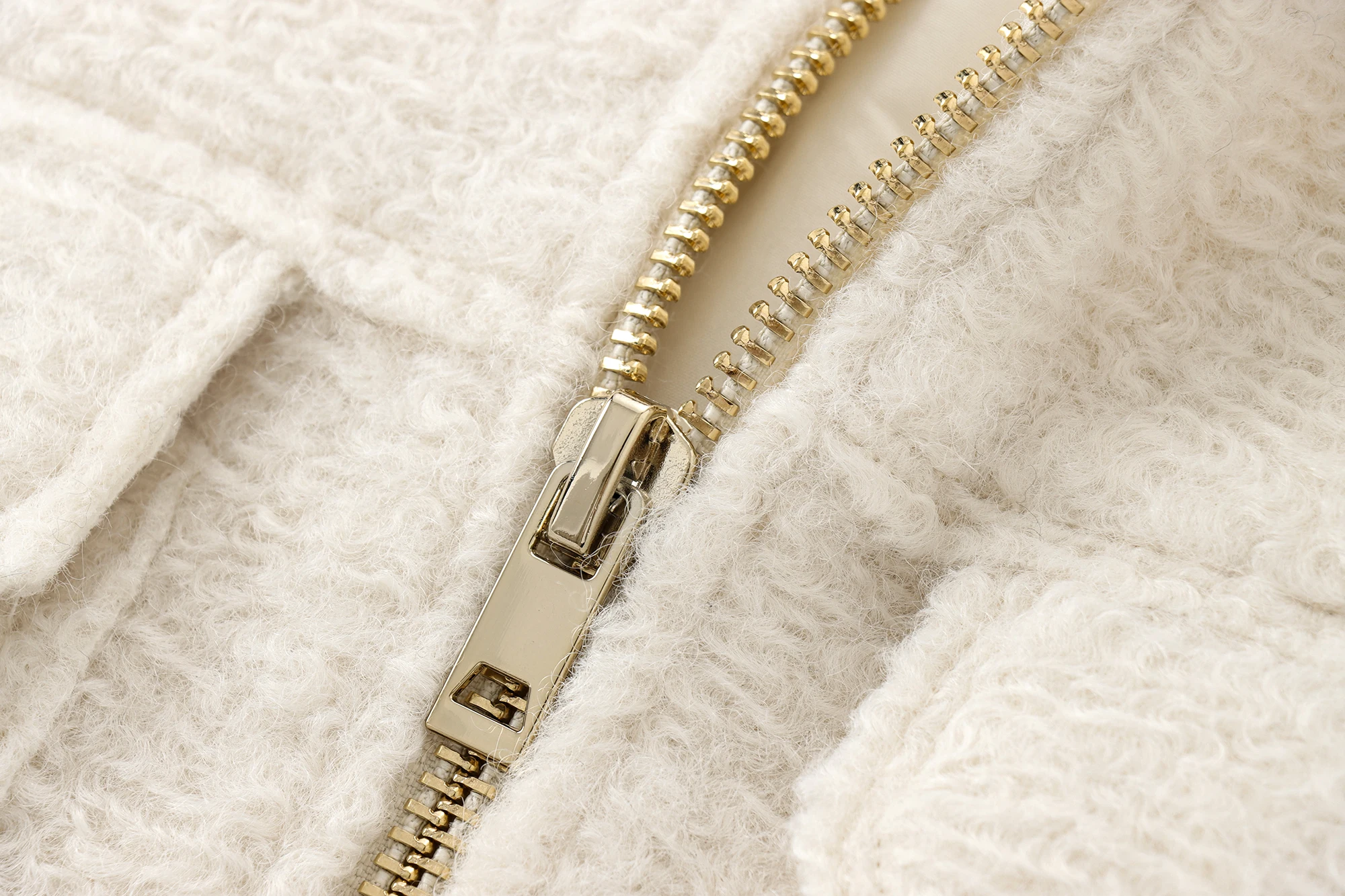 Detail view of the zipper closure and functional patch pockets.