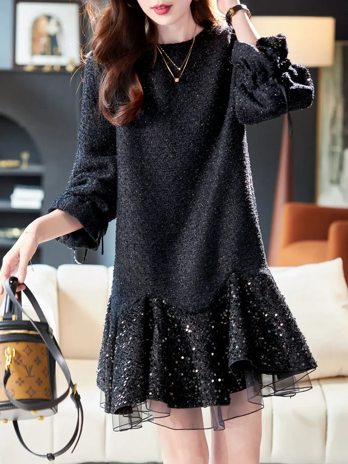 Woman wearing a black mesh sequin splicing dress with slim silk midi skirt in elegant evening style full