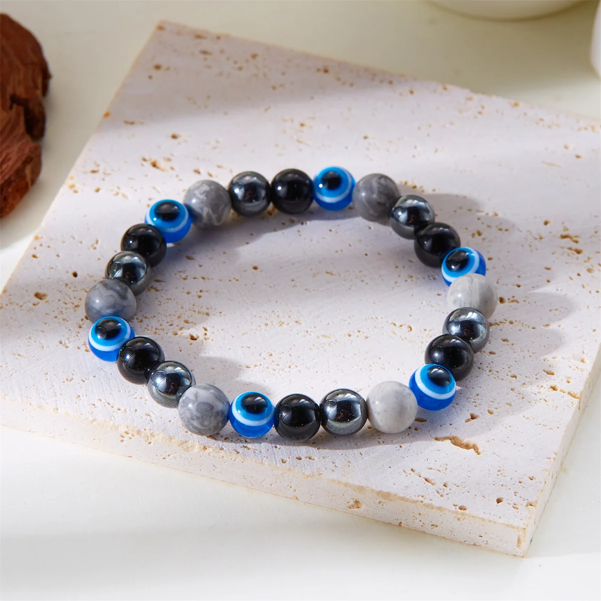 Natural stone intention bracelets displayed on neutral fabric