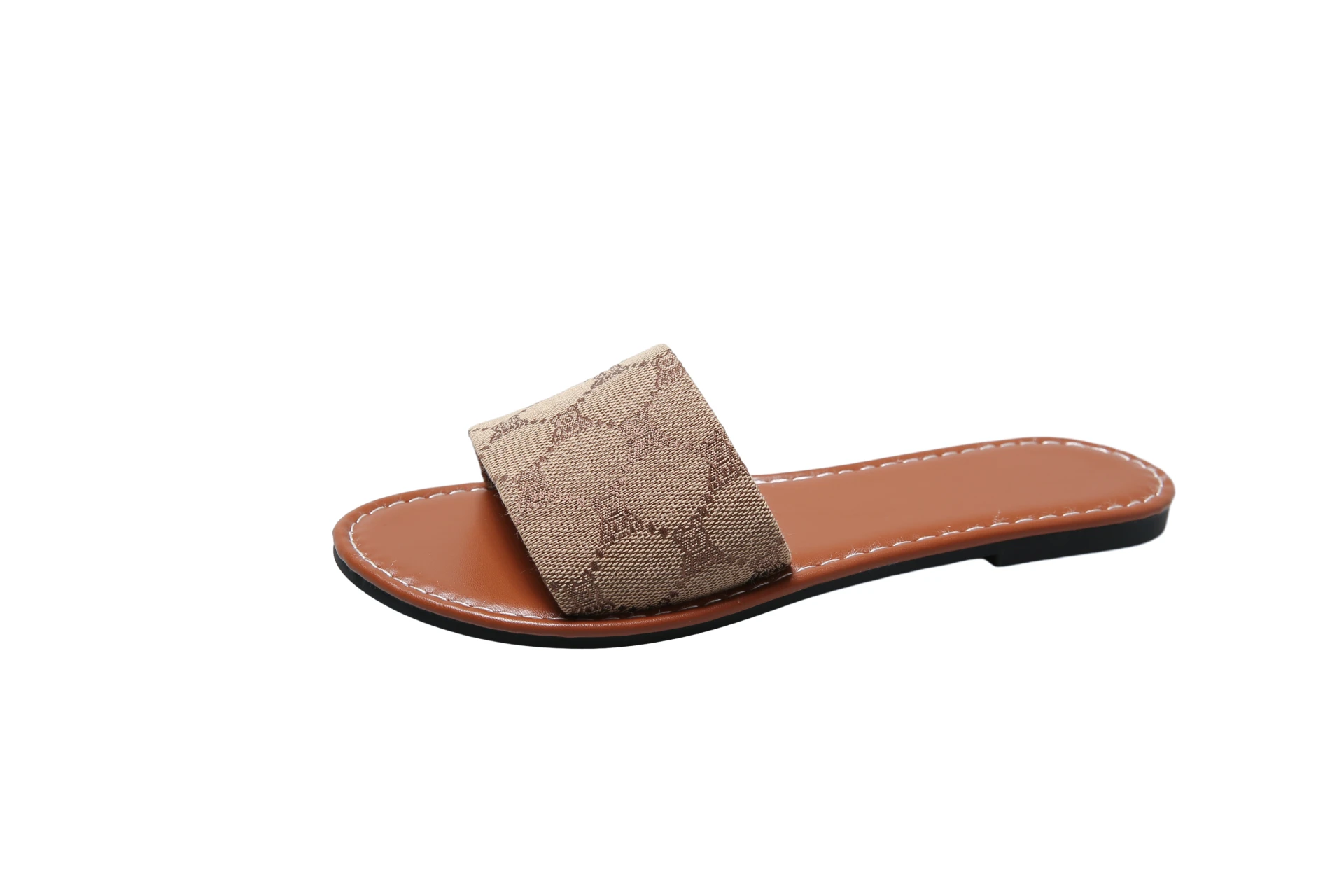 The French Sole sandal features a wide brown fabric strap with a subtle pattern, tan footbed, white stitching, and black sole—perfect for adding British Style to your summer look. Shown on a white background.