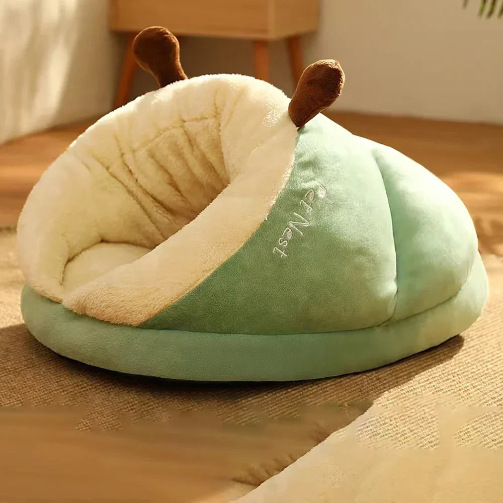Side profile of an empty, sage green Warm Pet Bed showing the "Pet Nest" embroidery and plush cushioned entry.