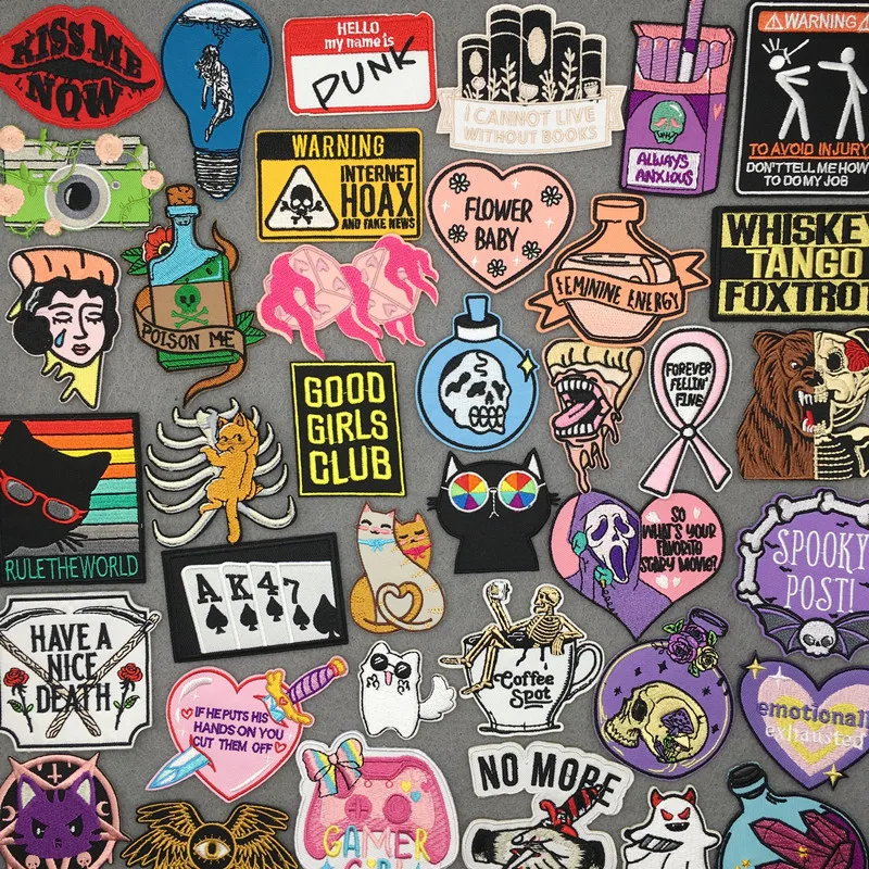 Gothic, feminist, punk and witchy embroidered patches – slogans, skulls, potions and cats on grey background
