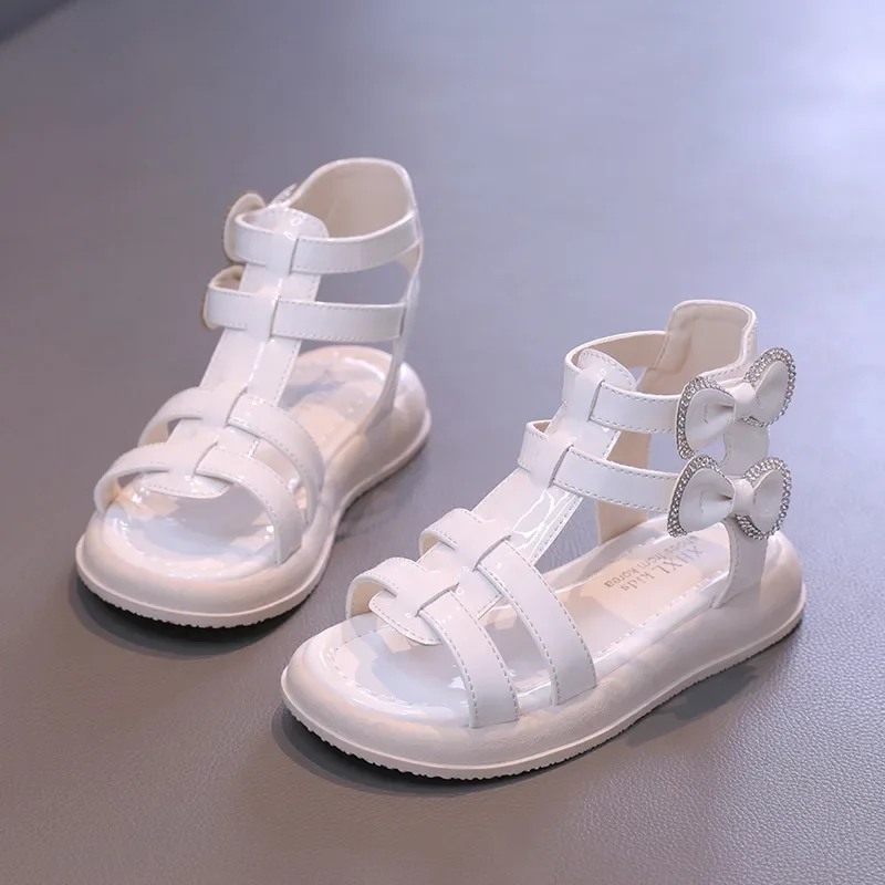 

Сандалии Детские однотонные глянцевые из ПУ кожи, модная летняя обувь на толстой подошве, повседневные босоножки в римском стиле с бантиком, черные