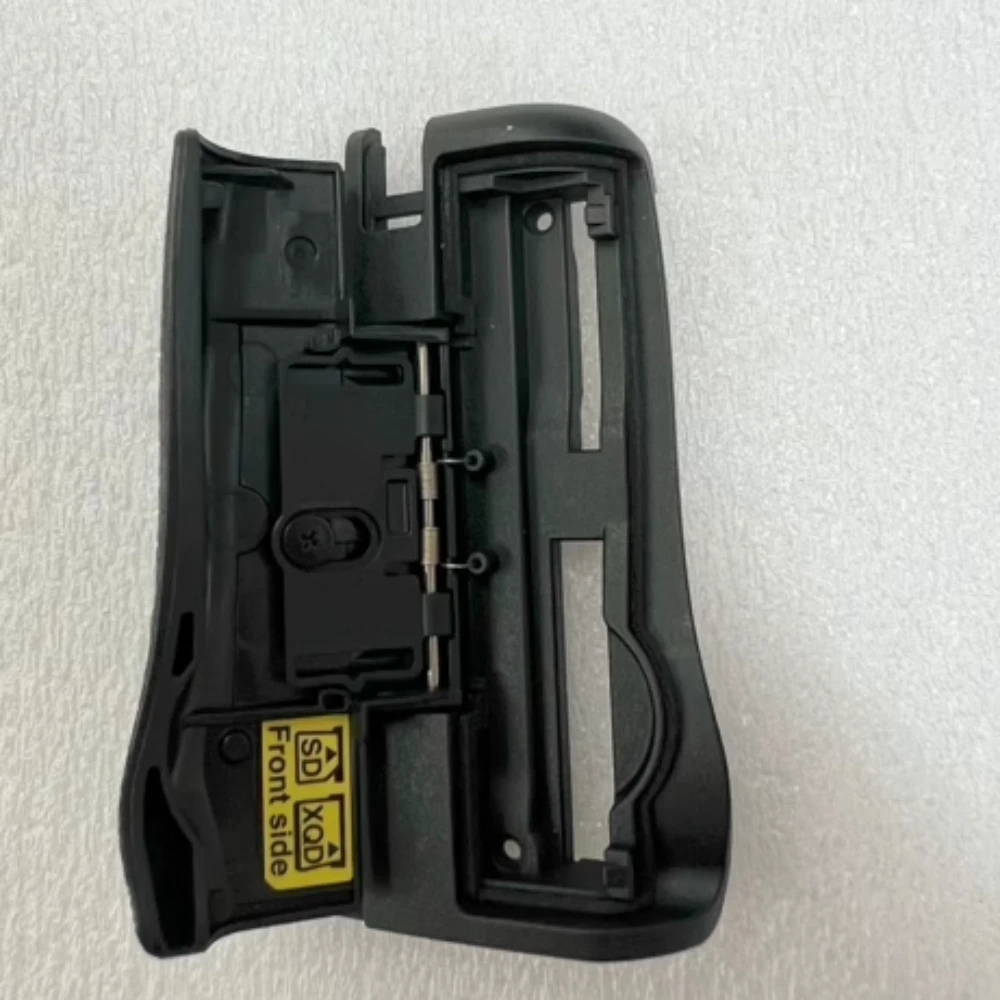 

Brand-new original for Nikon D500 card slot cover assembly with decorative rubber camera maintenance parts.