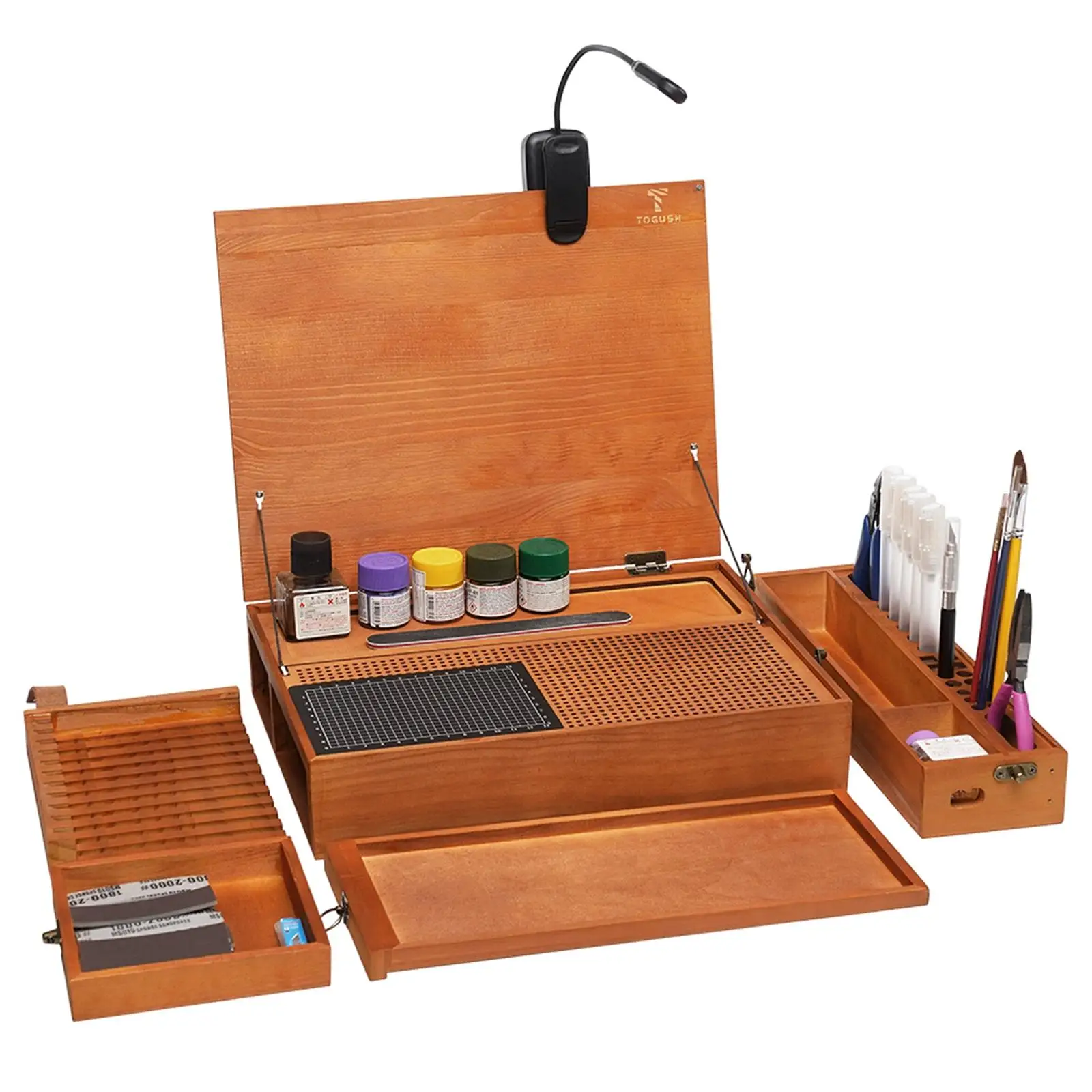 Établi pliable pour modélisme replié, compact et facile à ranger, avec poignée de transport.