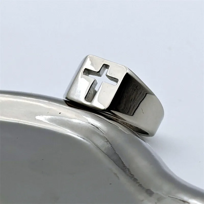 316L stainless steel hollow out cross ring for men and women, modern design on a reflective surface.