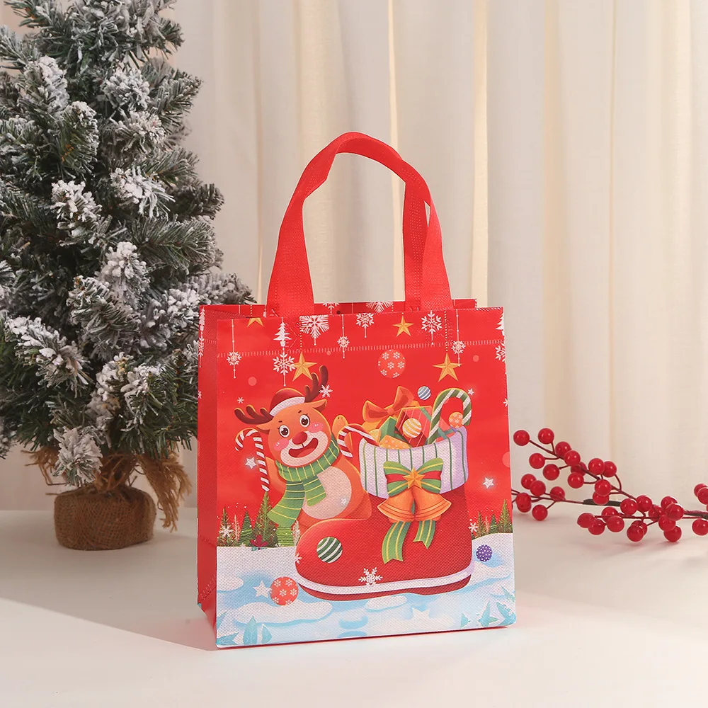 thumbnail image 1 of 4 bolsas de regalo de Feliz Navidad con asa de tela no tejida, bolsa de embalaje para dulces, bocadillos, muñeco de nieve y Papá Noel, decoración para fiestas navideñas, 1 of 5