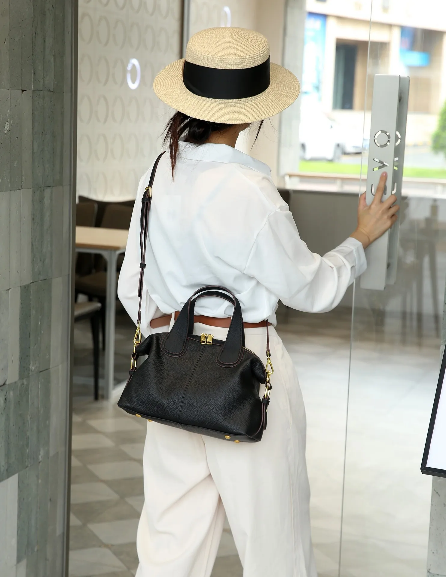 Elegant genuine leather crossbody handbag with shoulder strap and quality details