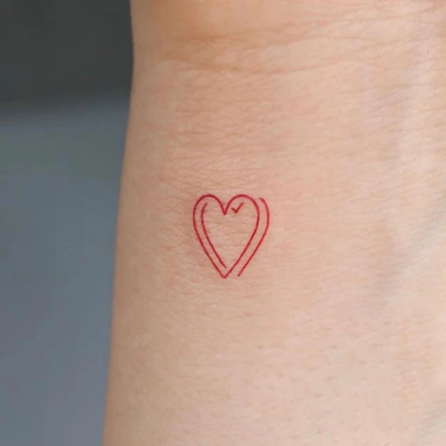 Red heart tattoo on the left side ribcage 