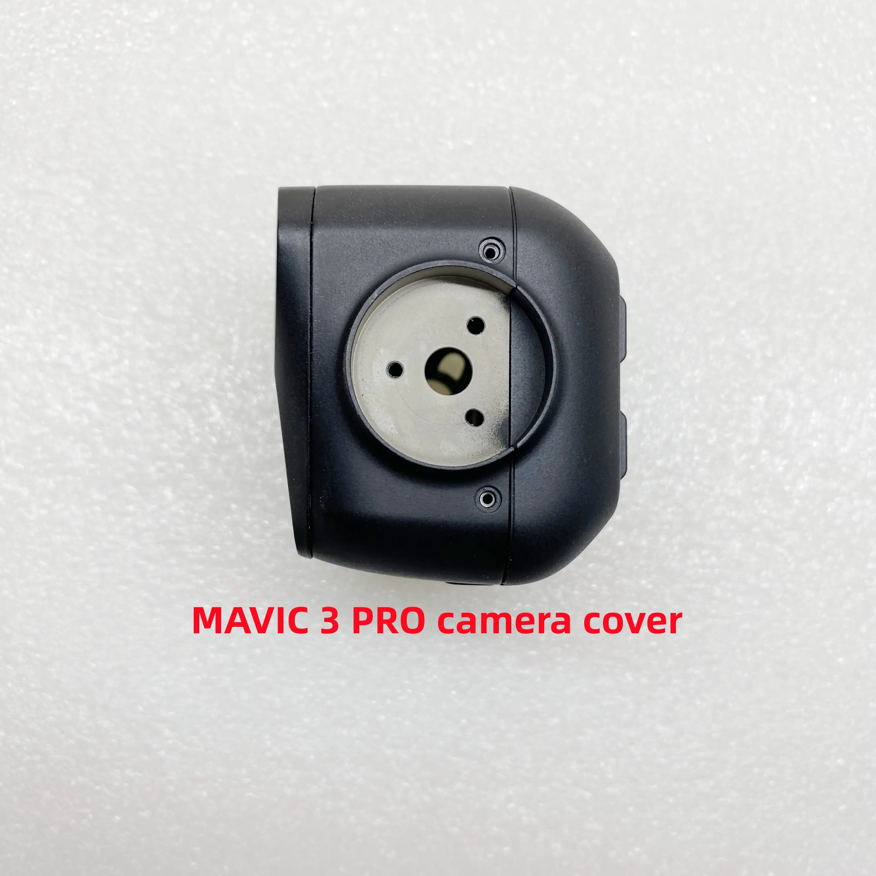 Détail de la coque de protection pour objectif DJI Mavic 3 Pro, pièces d'origine, avec le drone en arrière-plan.