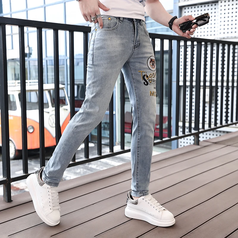 2024 spring and summer blue tiger embroidery men's jeans slim small feet trend casual printing light-colored pants