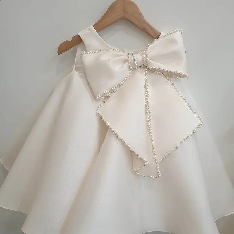 Babyhug Woven Sleeveless Solid Party Dress With Pearl Bow Appllique - White