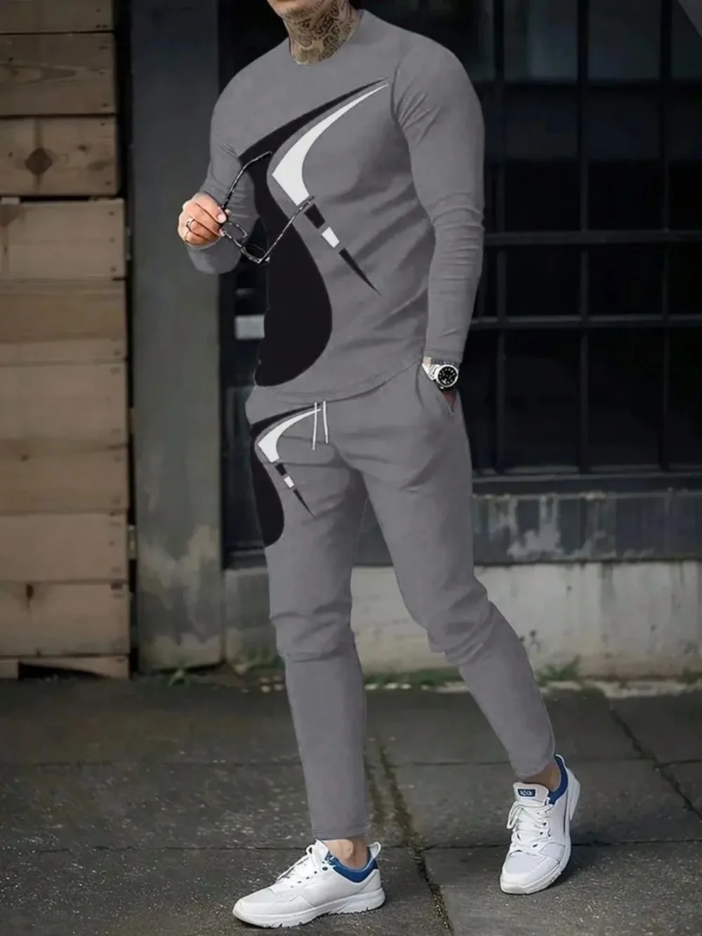 Man wearing striped patchwork long sleeve top and pants set in a sunny outdoor setting gray 03