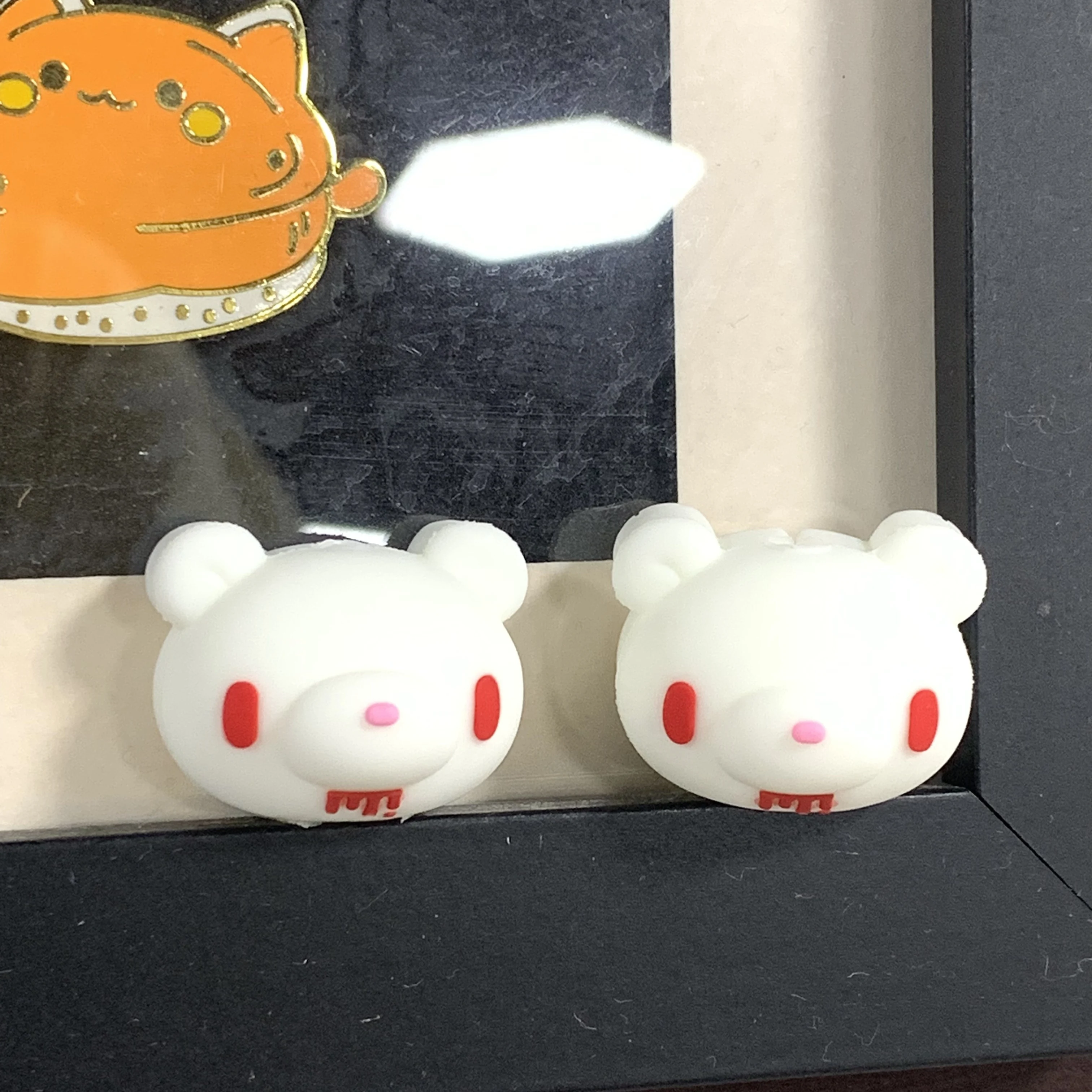 Fluorescent Gloomy Bear Cable Protectors Fluorescent Gloomy Bear cable protectors Iconic edgy-cute glow-in dark safeguard phone cables Perfect for fans