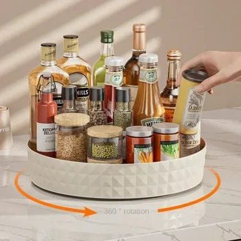 A white, single-tier turntable organizer spinning inside a pantry, neatly holding various spice jars and condiment bottles.