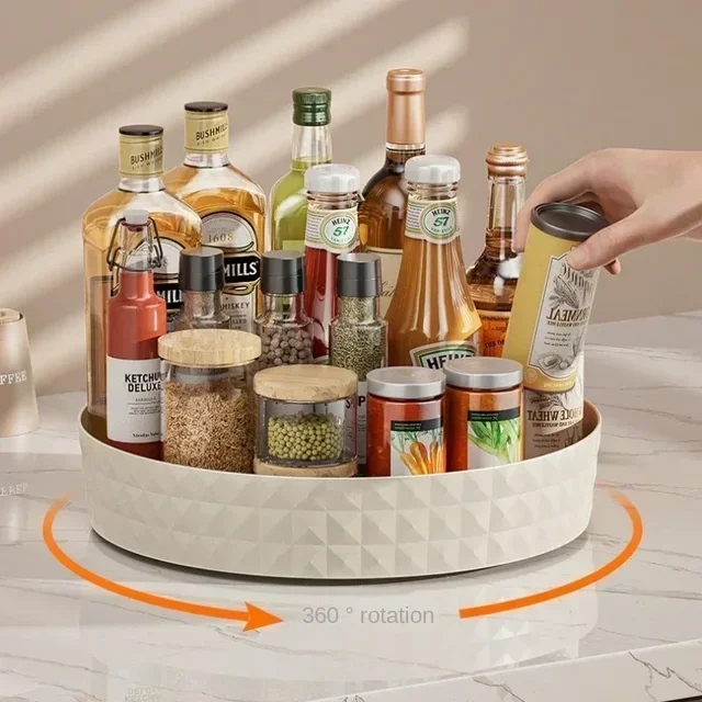 A white, single-tier turntable organizer spinning inside a pantry, neatly holding various spice jars and condiment bottles.