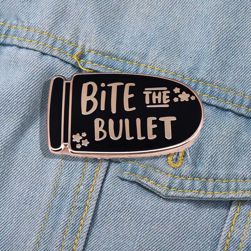 CartoonBulletEnamelPinEnglishSentenceBiteTheBulletAndGrit