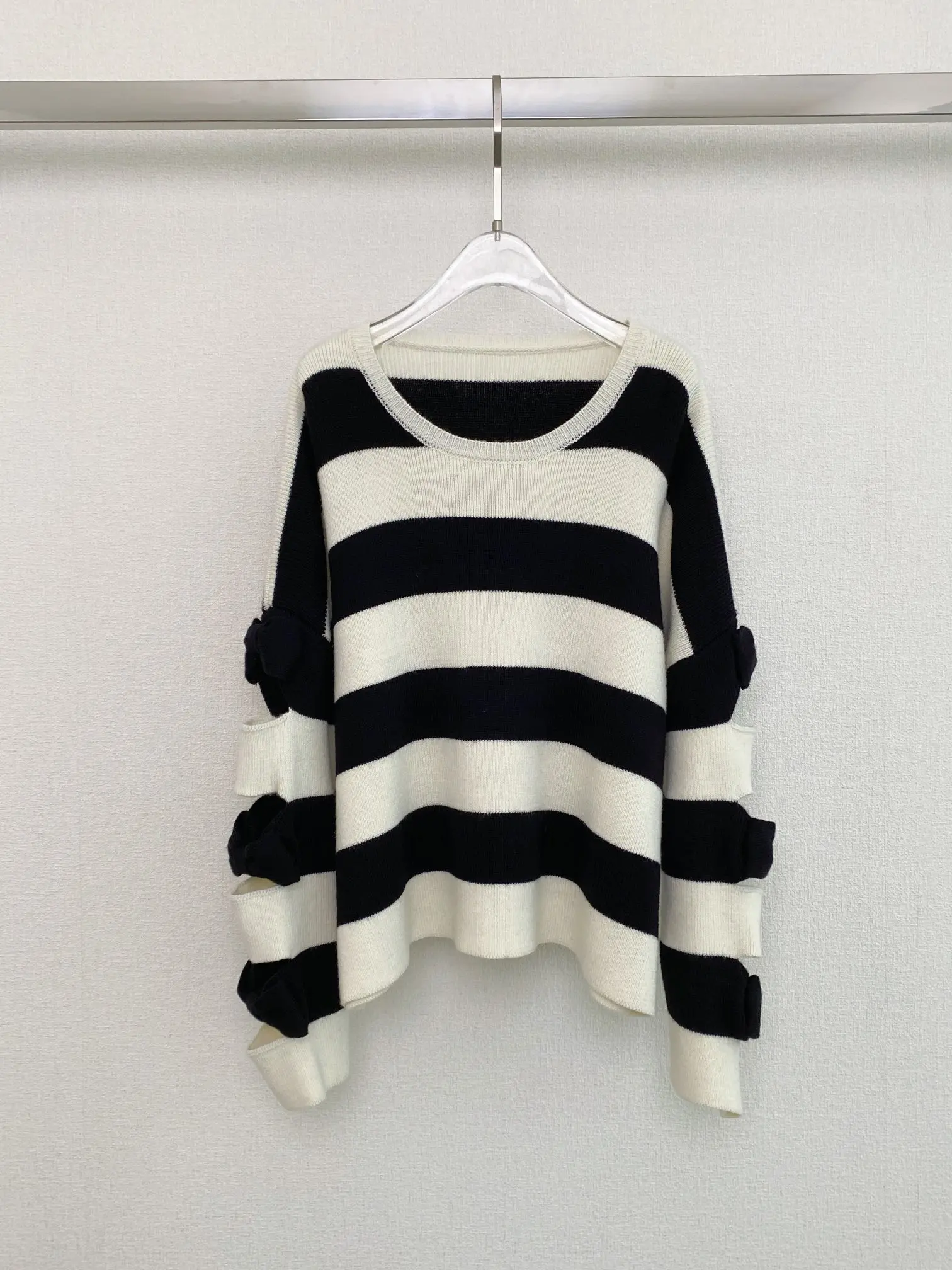 

2023 Women's Clothing Black and white striped bow hollow loose sweaterWinter New 1016