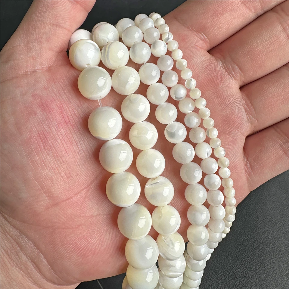 Bola per la gravidanza in oro con fiore di madreperla, foglia e