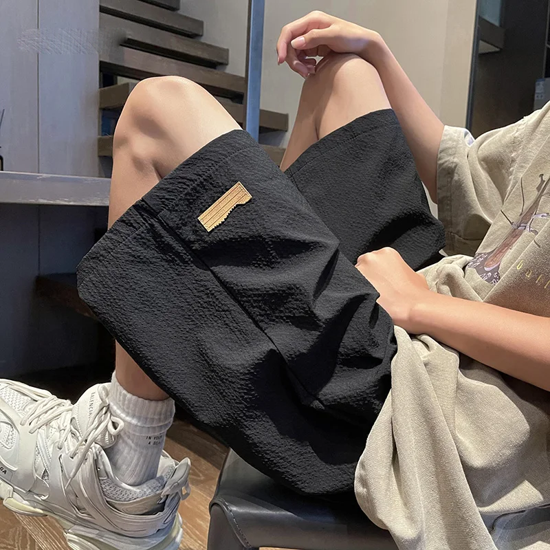 Fashion Solid Color Spliced Pockets Casual Shorts Men's Clothing 2024 Summer New Loose Elastic Lace Up High Waist Knee Shorts