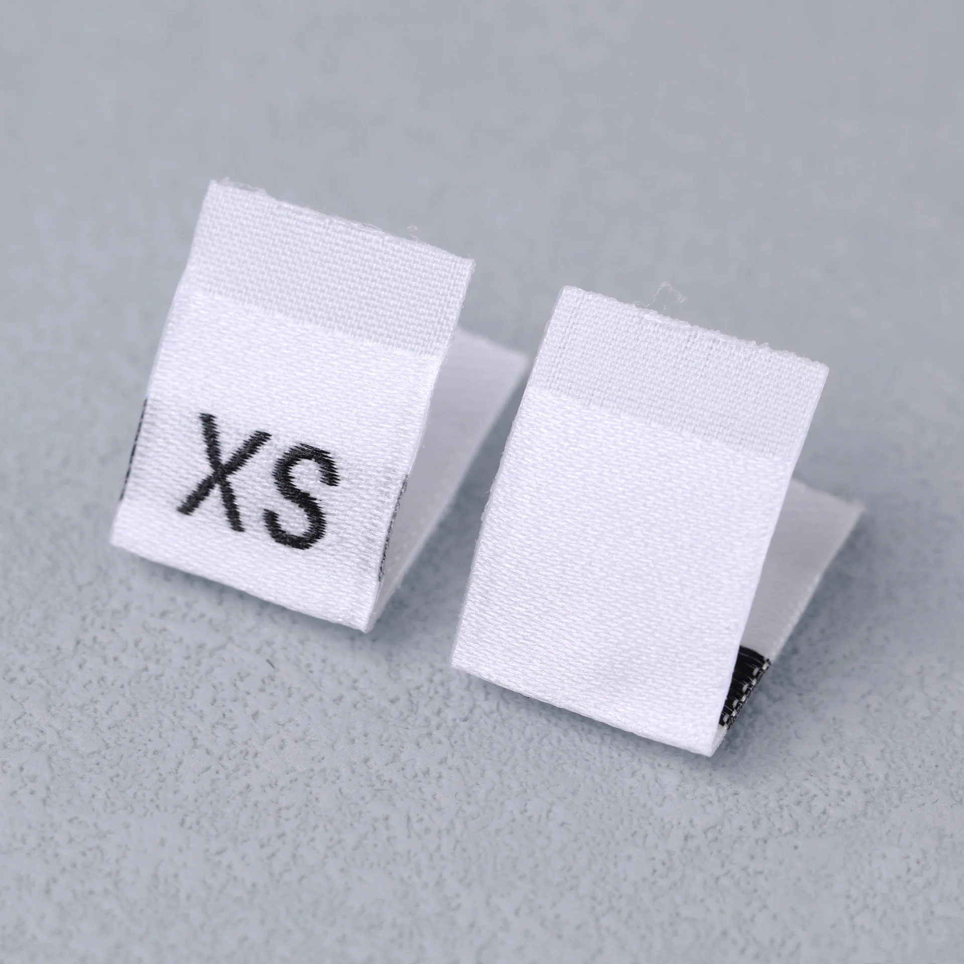 Description Picture 2 of item100Pcs Clothing Size Label Black Text White Garment Clothes T Shirt Dress Cloth Fabric Label Tag XS S M L XL 2XL 3XL 4XL 5XL 6XL