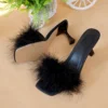 A pair of black women's casual high heels with soft chicken hair design and black high-heeled sandals