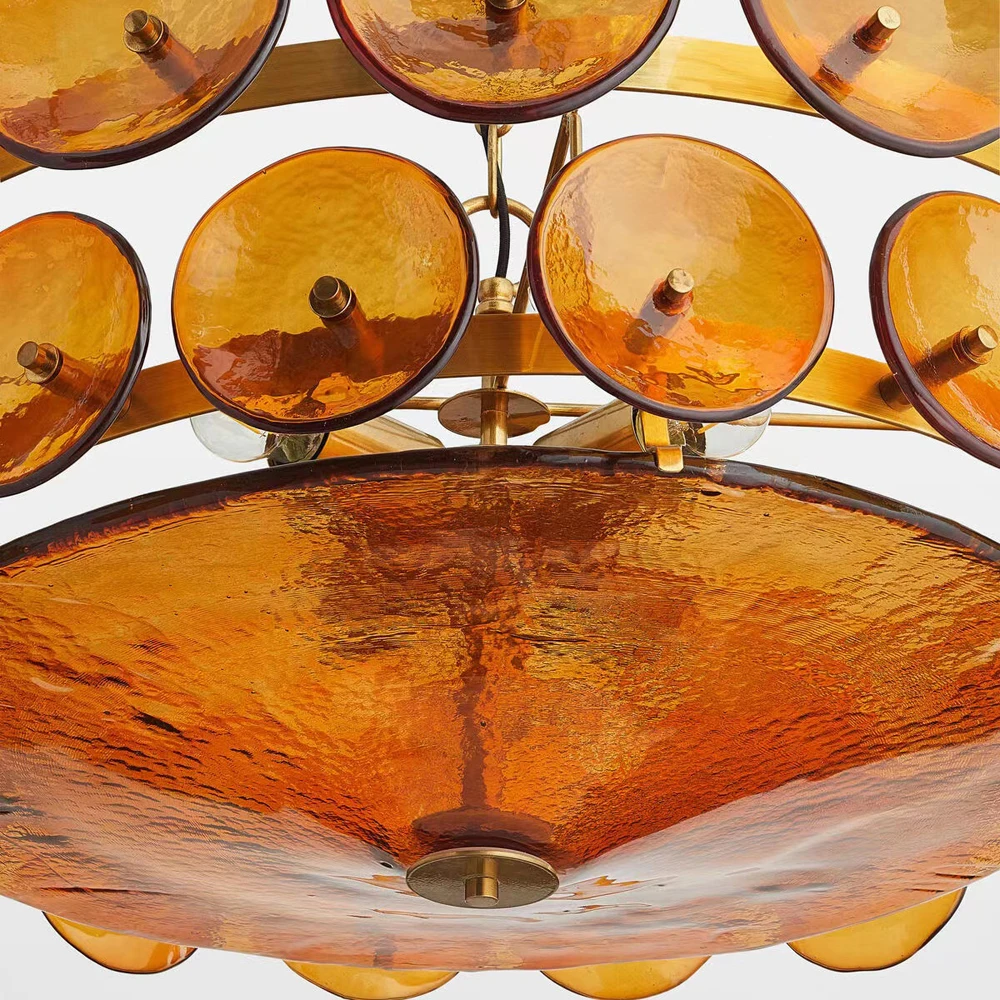 Close-up of the Italian Retro Pendant Light: a Mid-Century Modern chandelier with amber circular glass discs and brass fittings, showcasing exquisite Italian artisan lighting against a plain background.