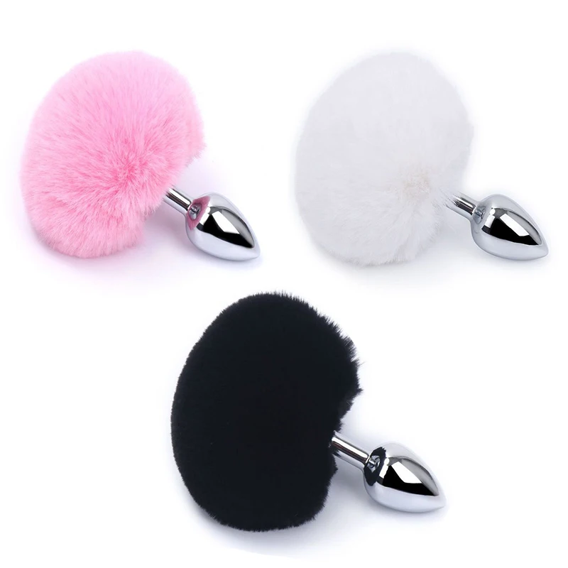 A toy with a pink, white, black anal plug and a 9cm long fur ball tail in multiple sizes