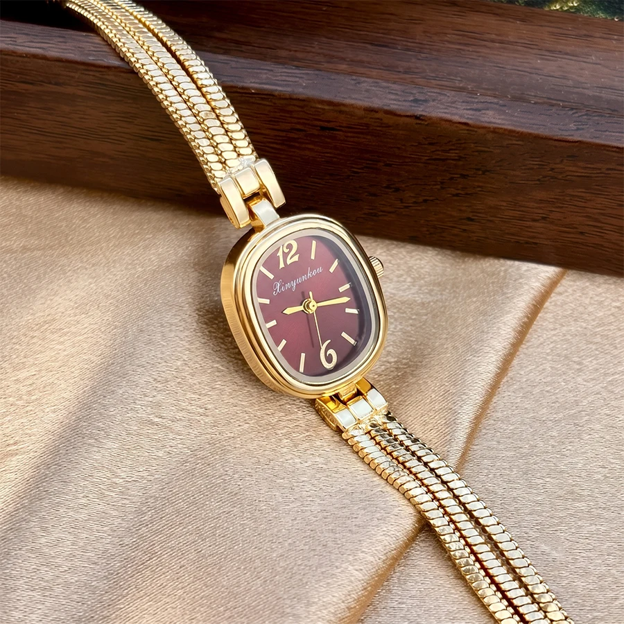 Elegant Gold Ladies' Watch with Oval Bead Face and Fringe Tassel Band