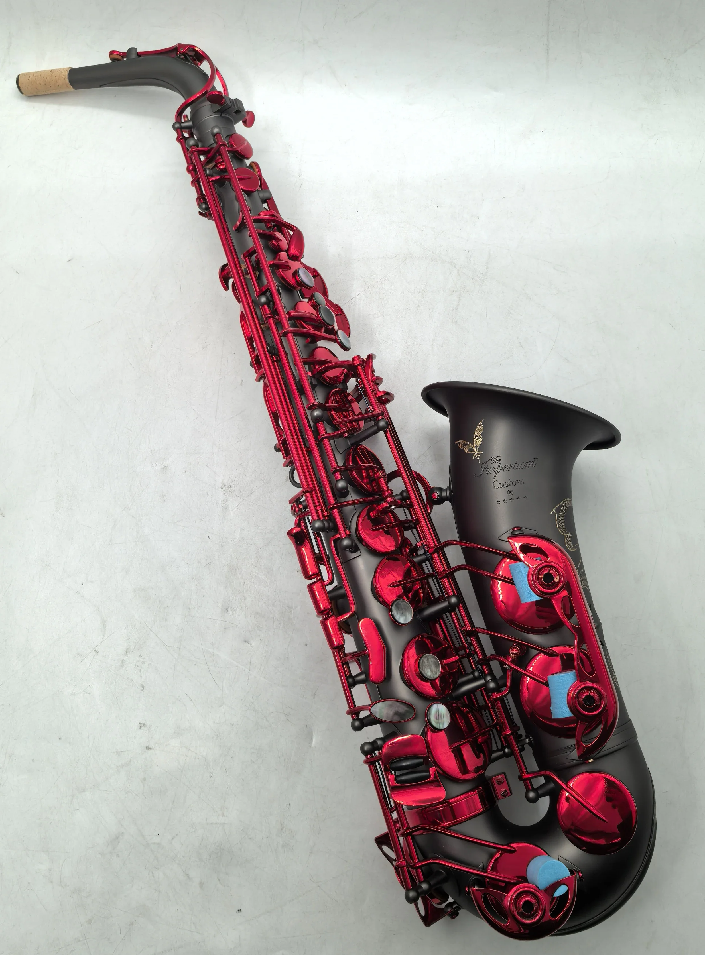 The Imperium matte black nickel plated Alto Saxophone with red lacquer keys