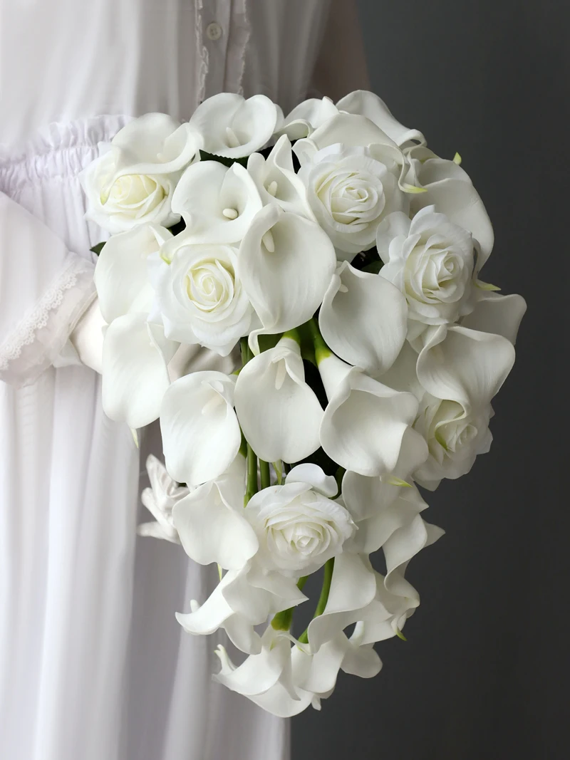 

white calla bridallilies holding flowers wedding bride holding flower calla lilies roses water drops holding bouquet