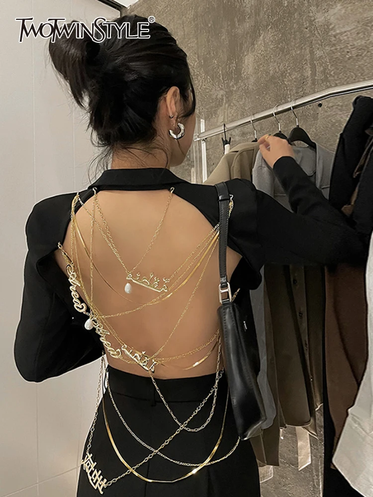 

TWOTWINSTYLE Back Cut Out Blazers For Female Lapel Collar Long Sleeve High Waist Slim Patchwork Metal Chain Coats Female 2022