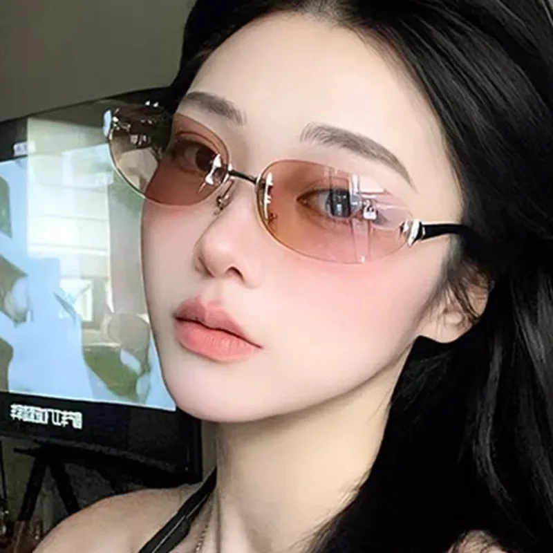 Y2K rimless elliptical fashion sunglasses with tinted lenses