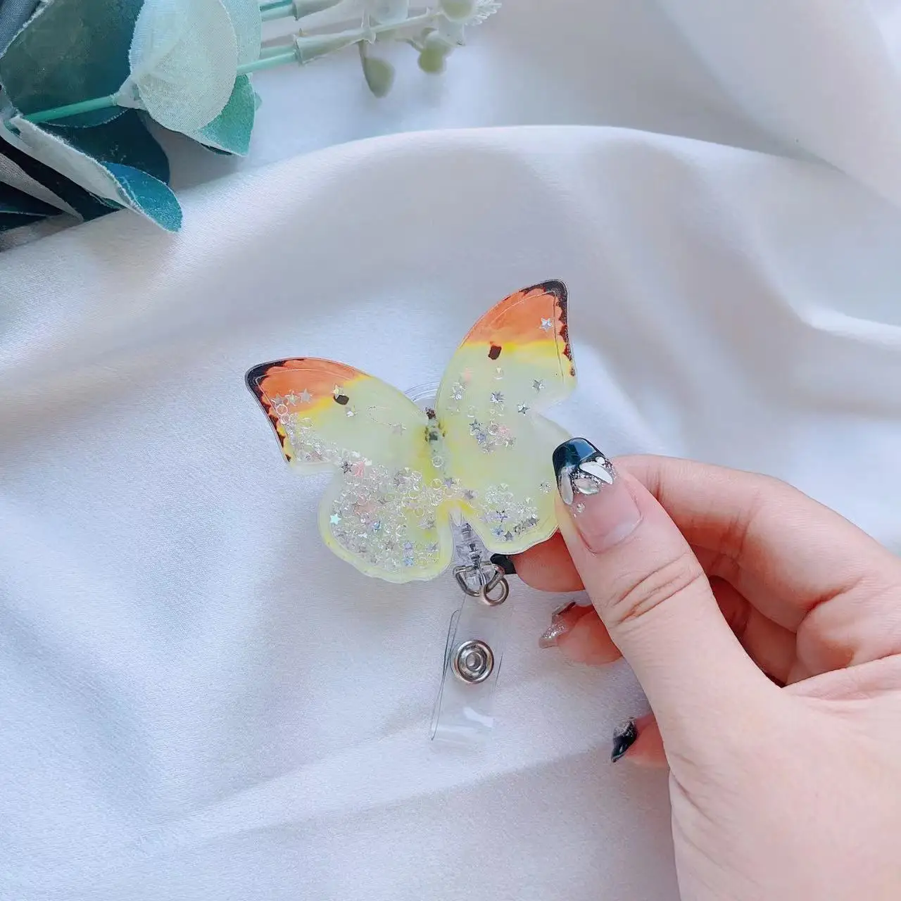https://ae01.alicdn.com/kf/S6926117299724ffb9580342a9d34d7e37/1Pc-Cute-Butterfly-Acrylic-Resin-Quicksand-Badge-Reel-Retractable-Decorative-Badge-With-Clip-Nurs-On-ID.jpg