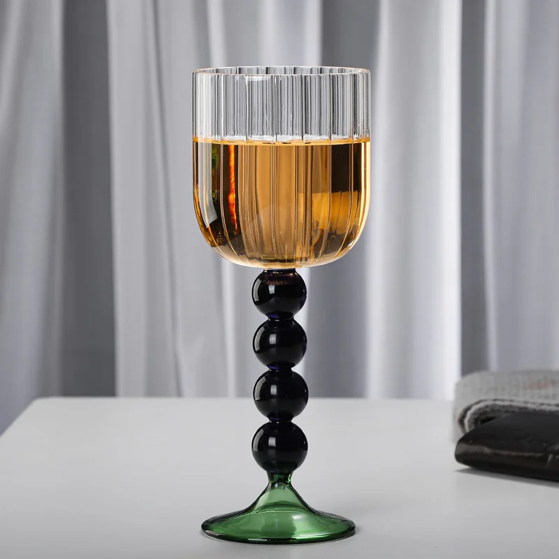 https://ae01.alicdn.com/kf/S6a0f9c96e9a64f1b94ac5588125438cf2/Vintage-Goblet-360ml-120z-Creative-Nordic-Ripple-Wine-Glasses-With-Blue-Amber-Ball-Pink-Curved-Stem.jpg