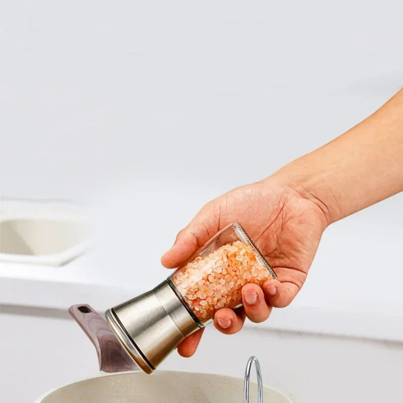 Kitchen supplies, manual grinder, pepper, Sichuan peppercorns, coarse salt, cumin, sesame seeds, and other sprinkling bottles