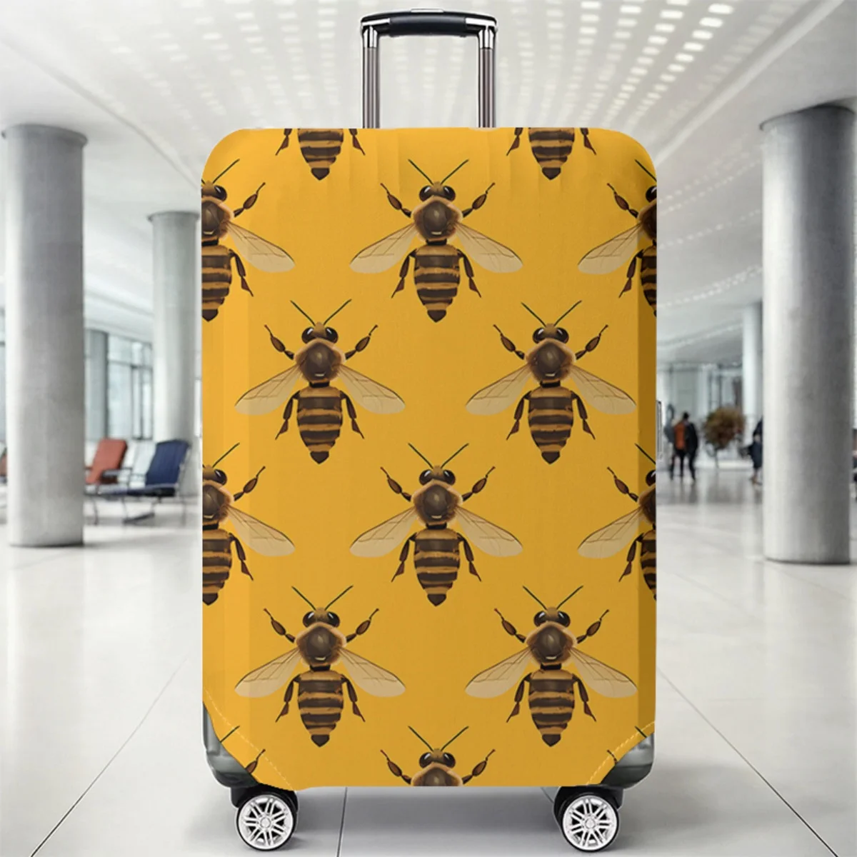 Elastic yellow suitcase protective cover featuring a repeating brown and black bee print pattern on a rolling luggage.